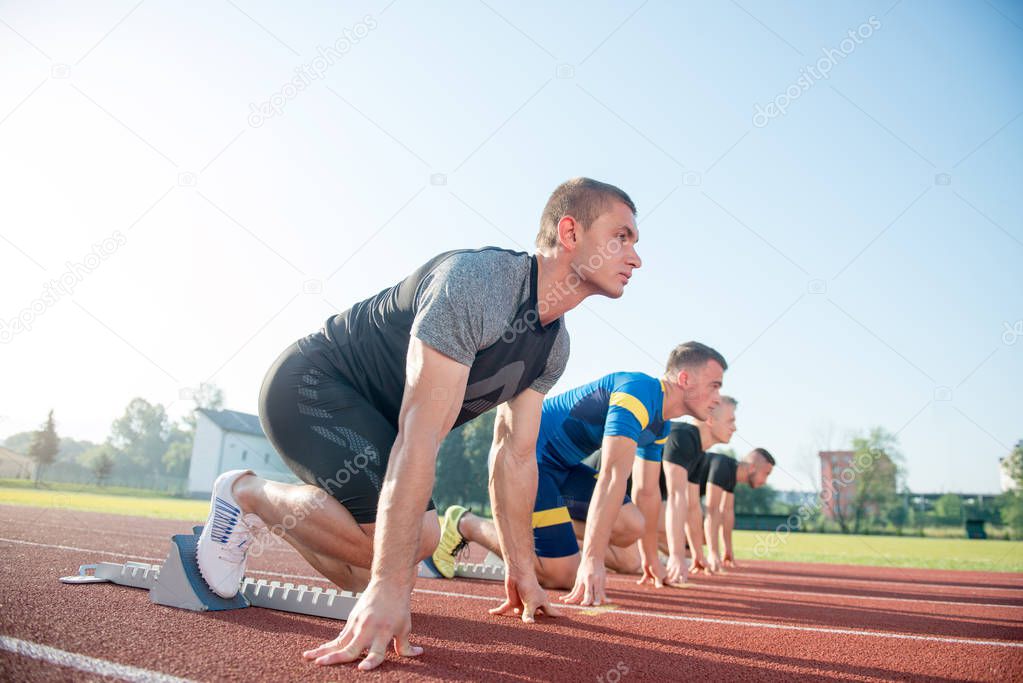 People ready to race on track field