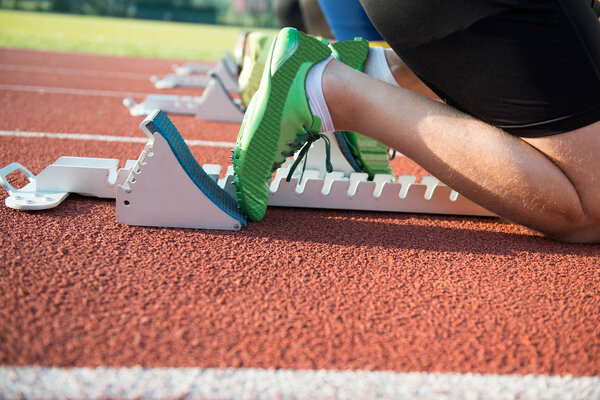 Feet on starting block ready for a spring start.