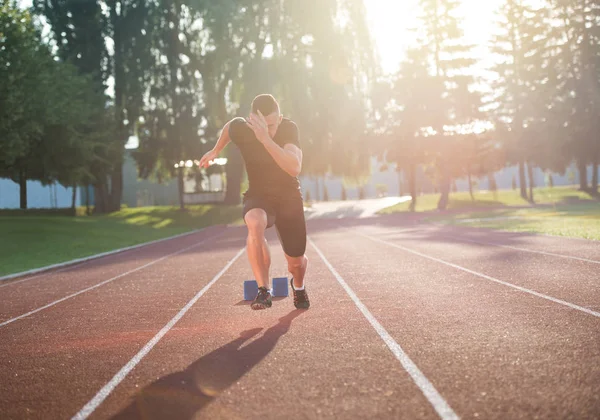 Sprinter, opustil startovací bloky na běžecké dráze. — Stock fotografie