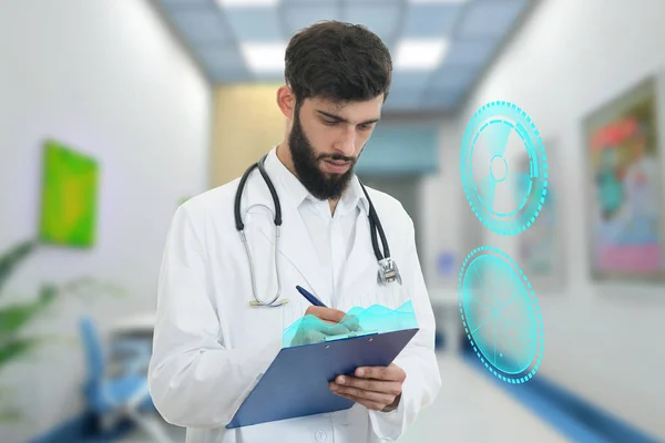 Worried young doctor with beard holding paperclip — Stock Photo, Image