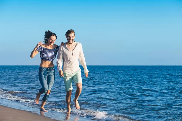 Coppia felice che corre sulla spiaggia — Foto Stock