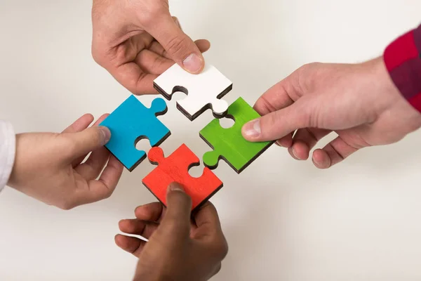 Business people group assembling jigsaw puzzle — Stock Photo, Image