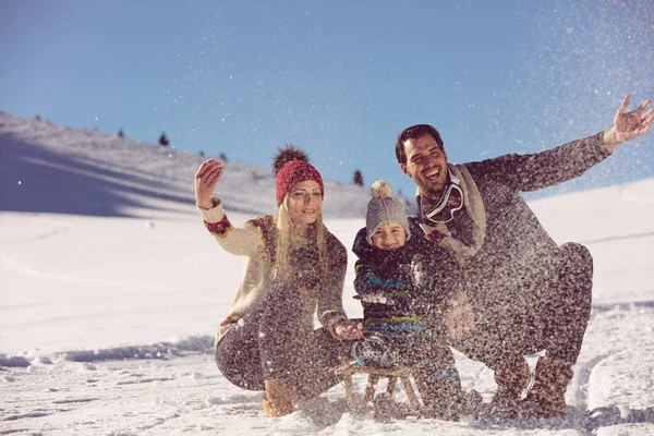 Família com criança no trenó no inverno — Fotografia de Stock