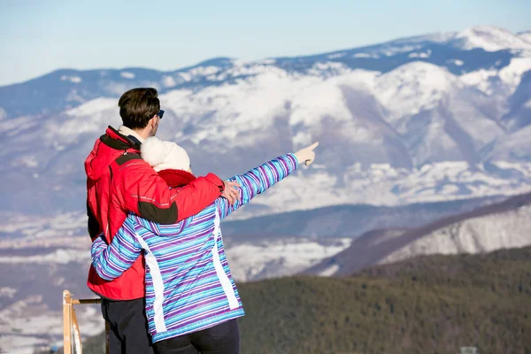 Loving couple at snowed mountain range Stock Picture