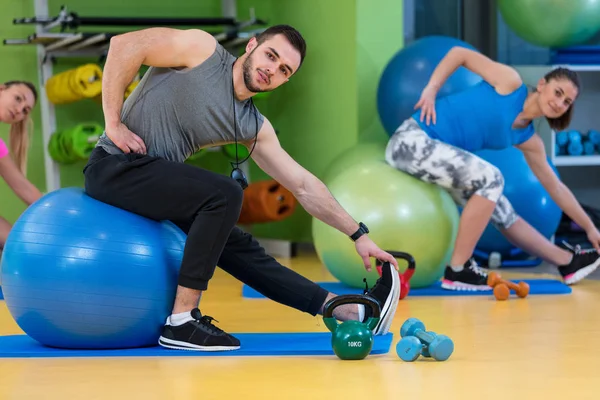 Ejercicio grupal en pelota suiza en el gimnasio —  Fotos de Stock