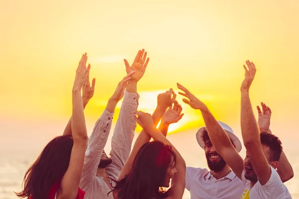 insanlar elleriyle sahilde dans. 