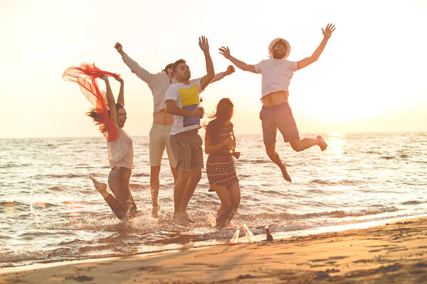 young people dancing at the beach