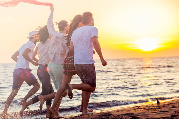 young people running on beach 