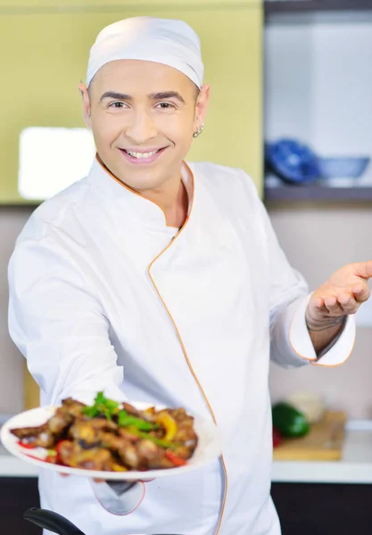 Cook holding plate with food — Stock Photo, Image