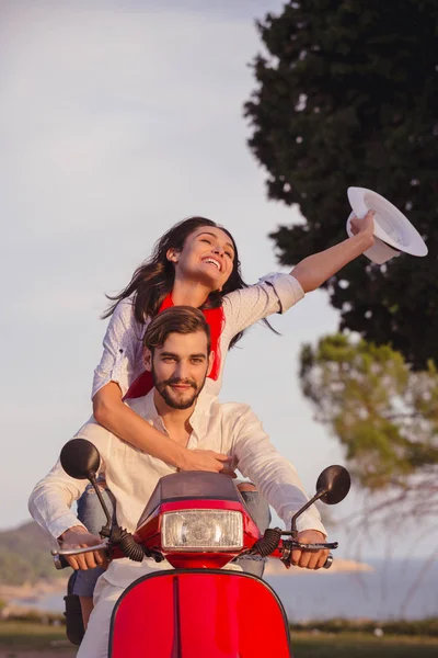 Happy couple riding scooter.