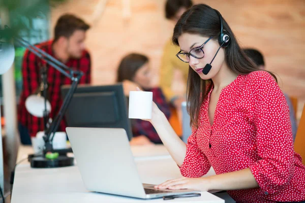 Female working wearing headset — Stock Photo, Image