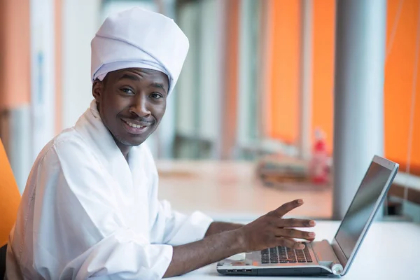 Sudanese businessman typing on keyboard