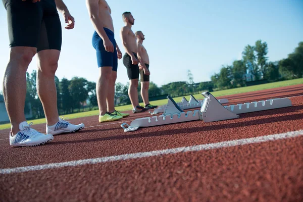 Athlétisme masculin coureurs sur la ligne de départ sans chemises . — Photo