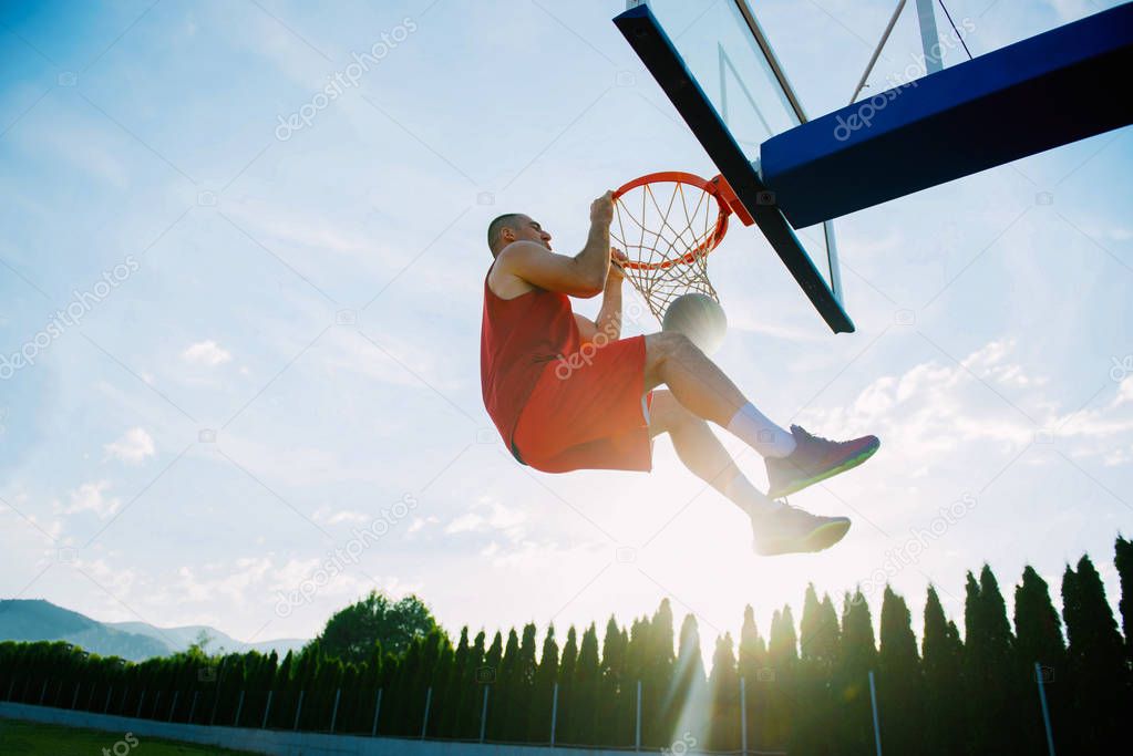 man making a fantastic slam dunk 