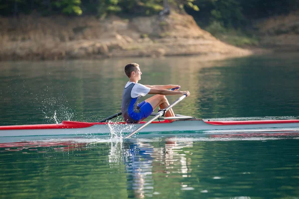 Un giovane concorrente canottaggio sul lago — Foto Stock