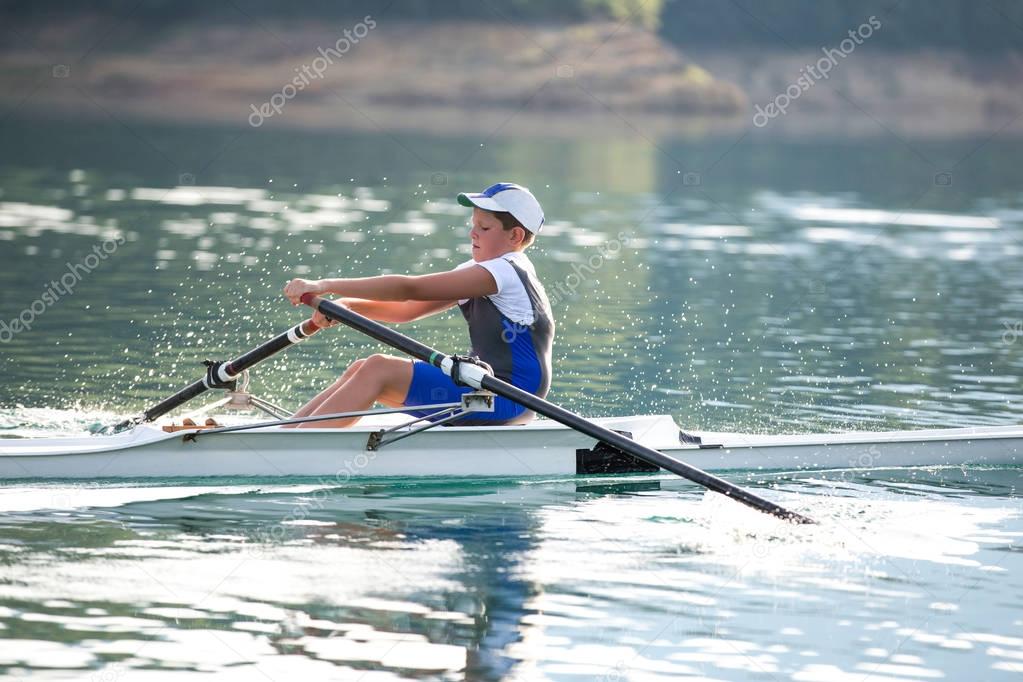 A Young rowing competitor on lake