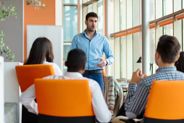 Man making presentation to team at office — Stock Photo, Image