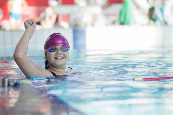 young and successful swimmers pose