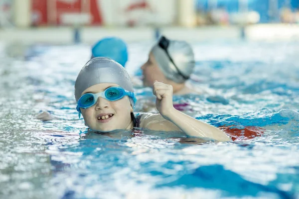 De gelukkige kinderen kids groep op zwembad klasse leren om te zwemmen — Stockfoto