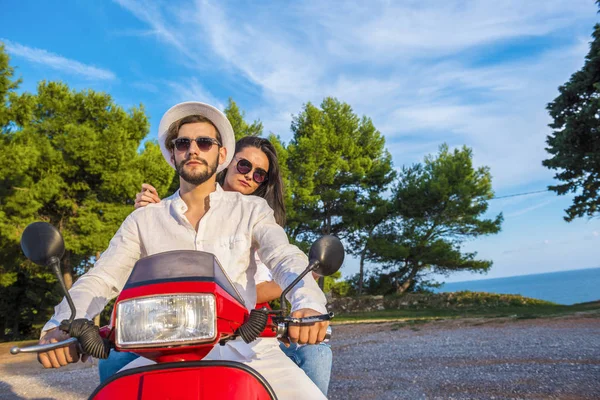 Happy free freedom couple driving scooter excited on summer holidays vacation.