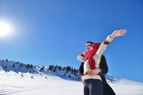 Feliz pareja juguetona juntos durante las vacaciones de invierno vacaciones al aire libre en el parque de nieve — Foto de Stock
