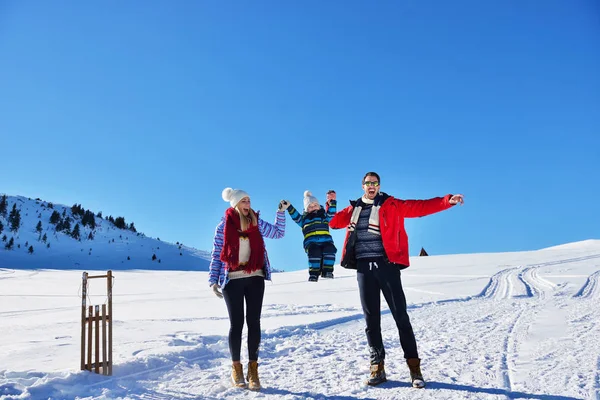 Happy young family playing in fresh snow at beautiful sunny winter day outdoor in nature — Stock Photo, Image