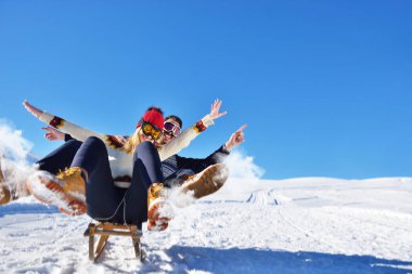 Kızak ve güneşli kış gününde zevk genç Çift