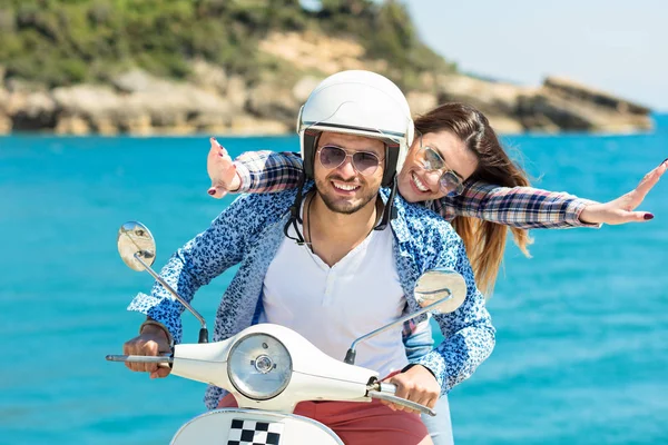 Junges Paar auf einem Motorroller unterwegs — Stockfoto
