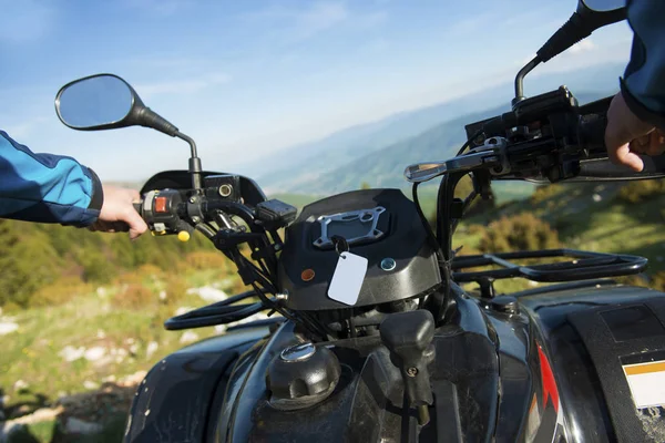 Young man on quad bike on a countryside trail. View from a quad bike.