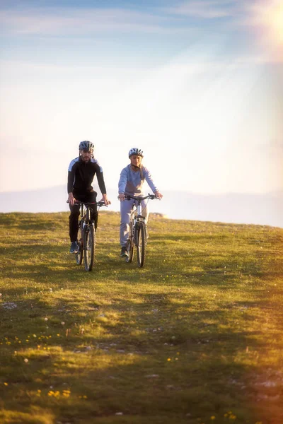 Feliz mountain bike pareja al aire libre divertirse juntos en un verano por la tarde —  Fotos de Stock