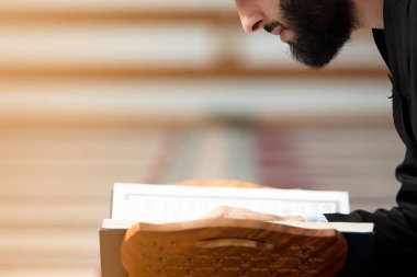 Dindar Müslüman adam caminin içinde dua ediyor.