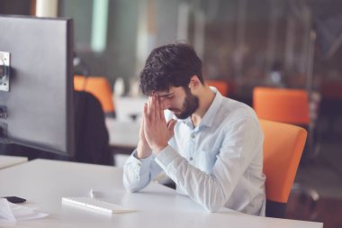 modern parlak başlangıç ofis iç onun masasında masaüstü bilgisayarda çalışan genç iş adamı