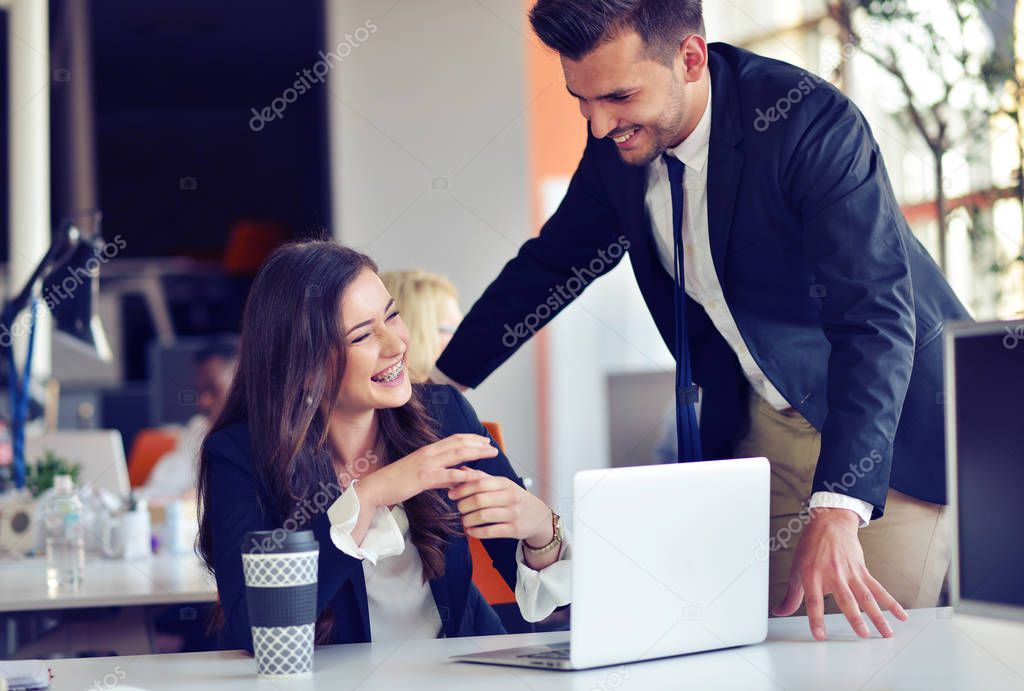 startup business concept with young multiethnic couple in modern office working on laptop