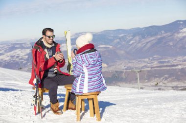 Bir çift salon üzerinde piknik bölgesinde Avrupa kayak merkezi üzerinde dinleniyor