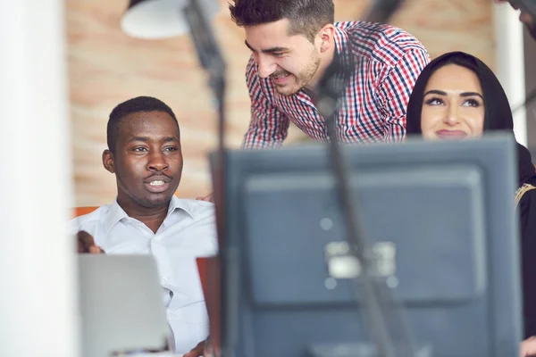 Multiracial contemporary business people working connected with technological devices like tablet and laptop