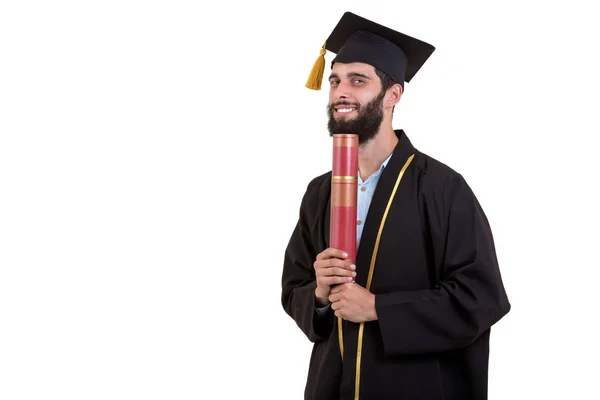 Estudante graduado vestindo vestido e boné isolado no fundo branco — Fotografia de Stock