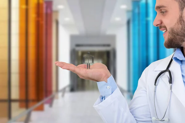 Retrato de un médico varón sonriente sosteniendo el símbolo de rayos X en las manos . — Foto de Stock