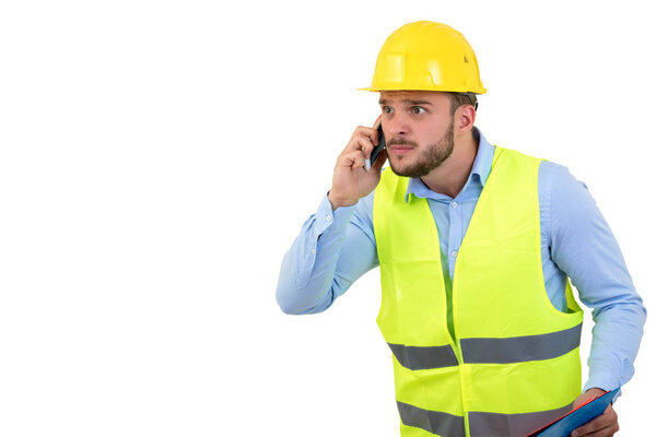 Angry upset young construction engineer yeling at the phone