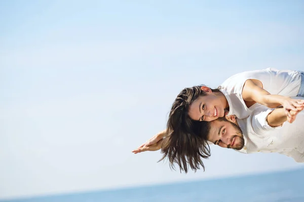 Una foto de una pareja feliz divirtiéndose en la playa —  Fotos de Stock