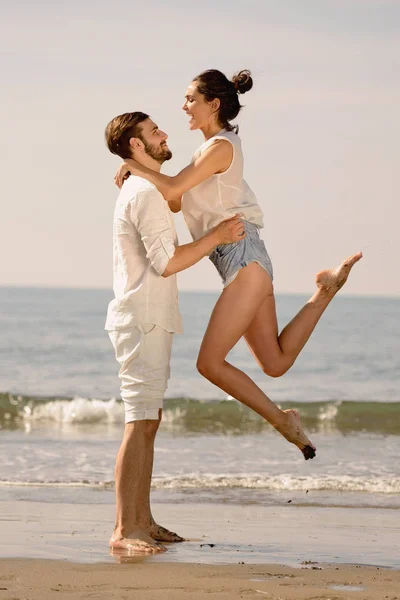 Ευτυχισμένο νεαρό ρομαντικό ζευγάρι ερωτευμένο διασκεδάστε στην όμορφη παραλία την όμορφη καλοκαιρινή μέρα. — Φωτογραφία Αρχείου