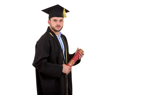 Étudiant masculin en robe de remise des diplômes gestuelle avec les mains isolées sur fond blanc — Photo