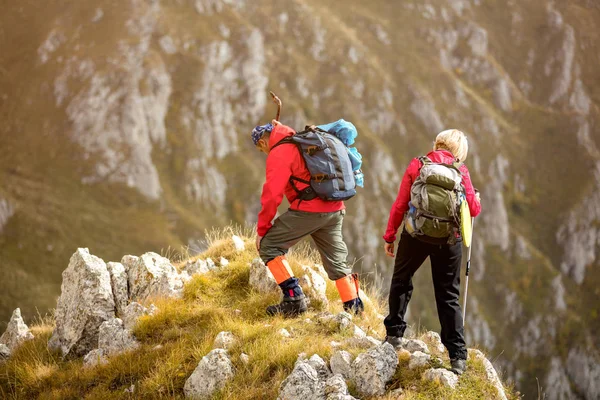 Adventure, travel, tourism, hike and people concept - smiling couple walking with backpacks outdoors — Stock Photo, Image