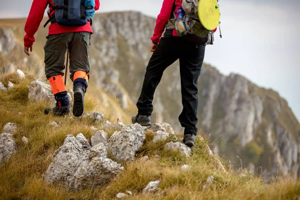 Adventure, travel, tourism, hike and people concept - smiling couple walking with backpacks outdoors — Stock Photo, Image