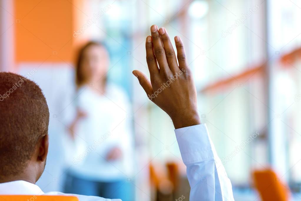 African american Business people Raising there Hand Up at a Conference to answer a question