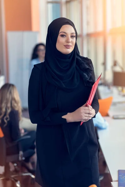 Arabian business woman holding a folder in modern startup office — Stock Photo, Image