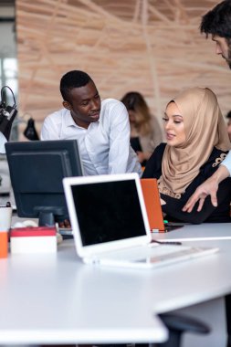 Girişim ekibi, modern parlak ofis içi beyin fırtınası, dizüstü bilgisayar ve tablet bilgisayar üzerine toplantı üzerine çalışıyor
