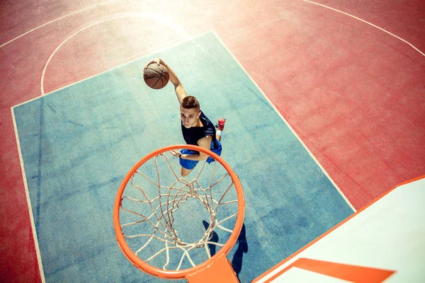 Hög vinkel syn på basketspelare doppning basket i båge — Stockfoto