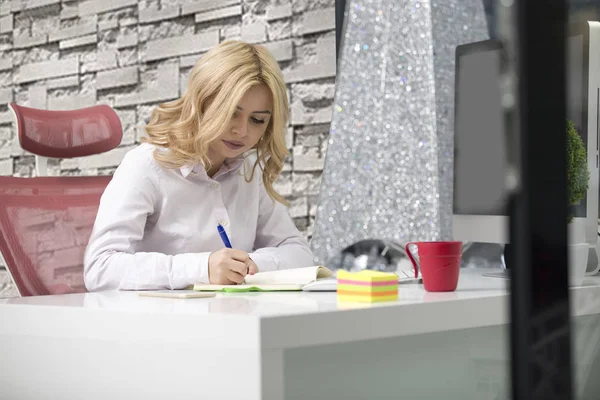 Business and entrepreneurship consept. Beautiful blonde business woman working on laptop