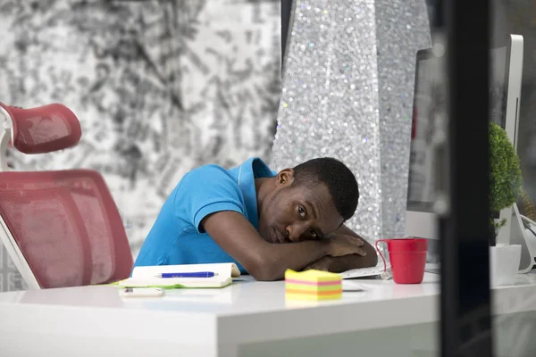 Furious black businessman tired of working on project at office.