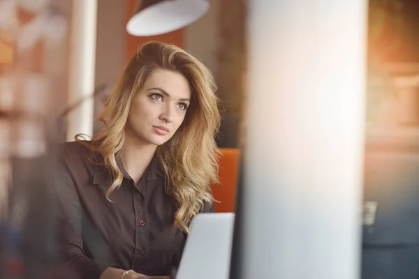 Portrait of cheerful employer of business enterprise enjoying creative working process in modern office indoors — Stock Photo, Image